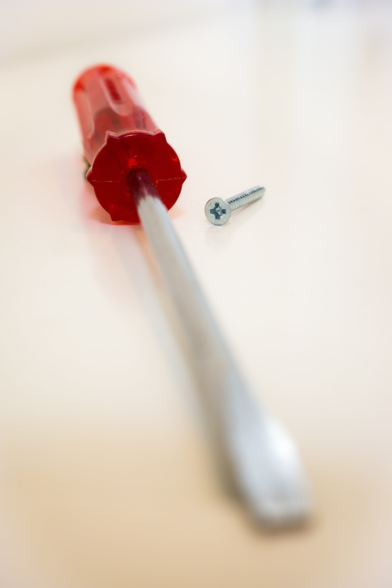 close-up, work, thumbtack, selective focus, white background, wrong, screwdriver, single object, focus on foreground, 5K, art and craft, metal, inappropriate