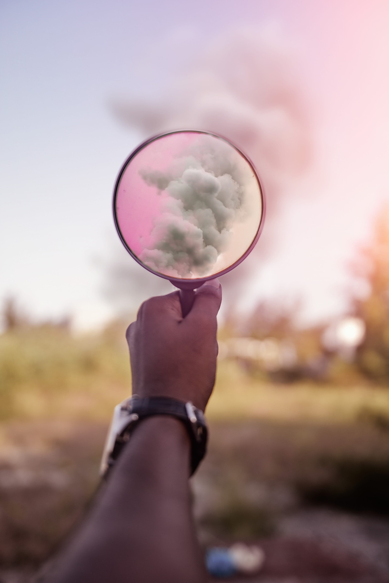 glass, human limb, human Hand, human body part, one Person, one woman only, plant, towards, people, finger, outdoors, pointed, sky, magnifying, leisure activity