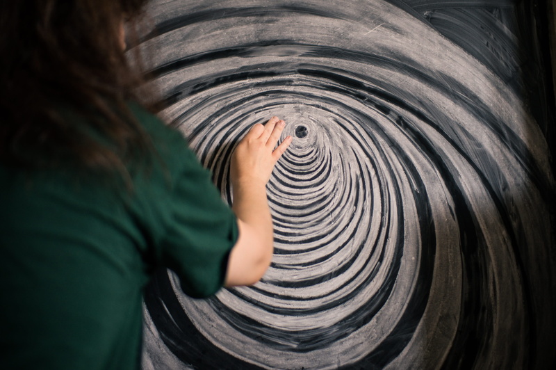 casual clothing, indoors, 4K, chalk, offspring, obscured face, finger, child, person, chalkboard, selective focus, human hand, unrecognizable person, headshot