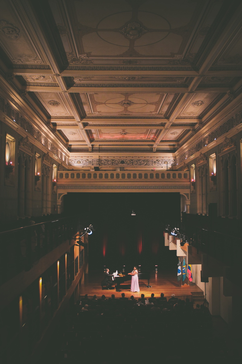 piano, audience, performing, people, house, seats, absence, built structure, in a row, interior, 5K, light, group, building, no people, chair, illuminated