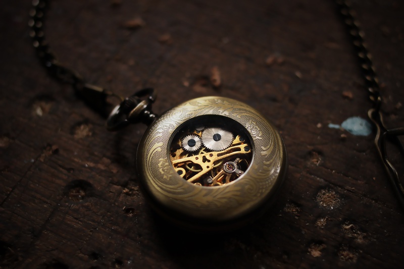 coin, indoors, jewelry, no people, dial, single object, gears, wood - material, pocketwatch, high angle view, gold colored, shape, silver colored, metal