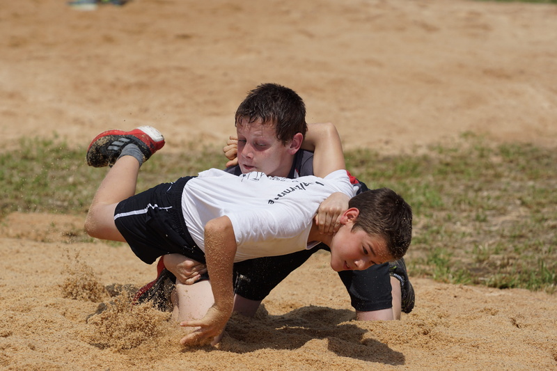 strength, teenager, leisure activity, boys, land, lifestyles, playing, adult, sand, full length, 5K, real people, hitting, Swing, lying down, competition