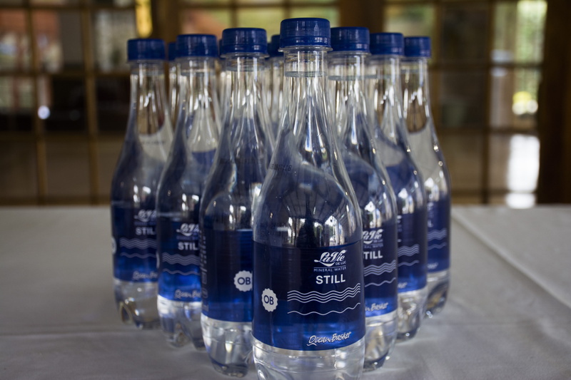 water bottle, container, transparent, label, focus on foreground, food and drink, no people, blue, drink, 5K, indoors, refreshment, still life, text, clean
