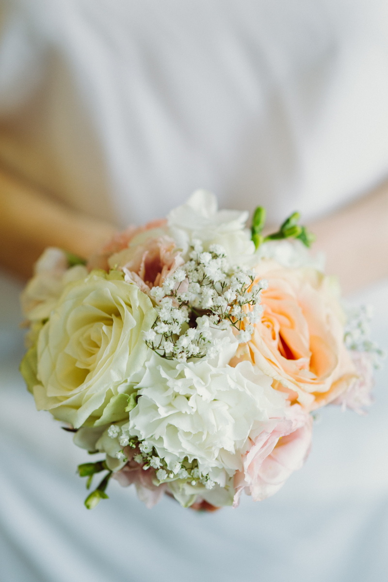 plant, indoors, celebration, one person, white color, vulnerability, flower head, adult, rose, focus on foreground, midsection, bouquet, freshness, beauty in nature