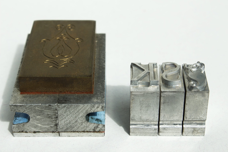 font, studio shot, architecture, letters, close-up, cast, art and craft, table, container, macro, creativity, metal, nature, box - container, mirrored