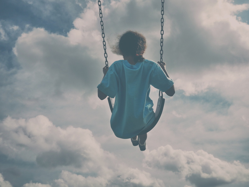 fun, black, child, woman, lifestyles, full length, blue, leisure activity, daytime, summer, cloud - sky, swing, outdoors, person, riding, nature, males