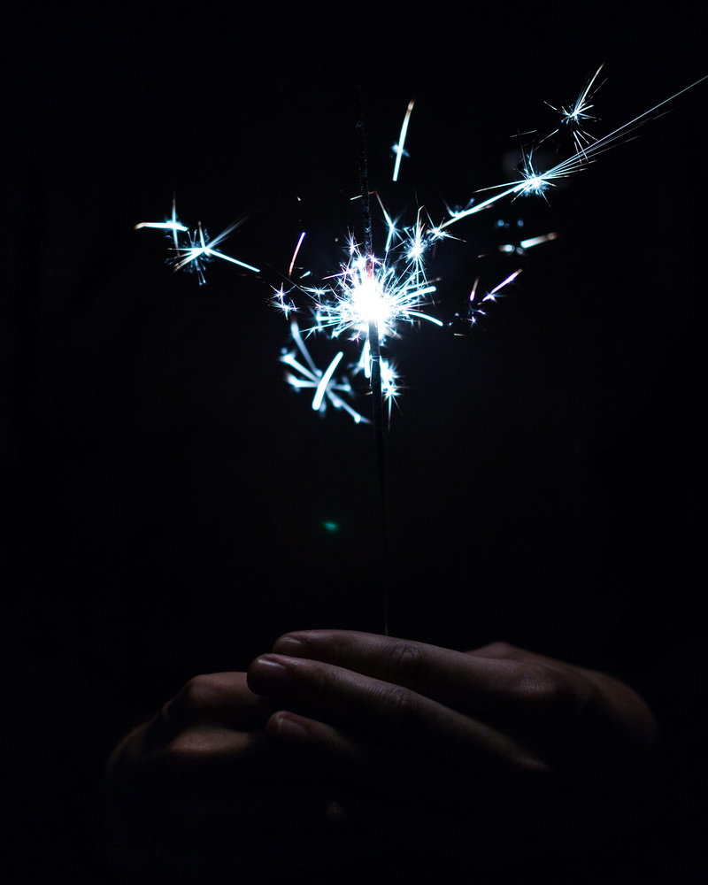 holding, fire - Natural Phenomenon, 2K, lifestyles, real people, person, finger, illuminated, human finger, sparkler, sparks, black Background, night