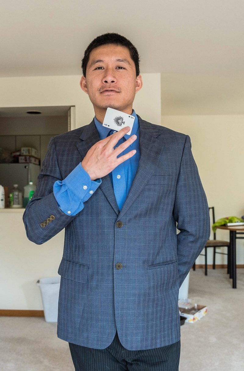 well-dressed, guy, males, indoors, men, looking at camera, 2K, businessman, front view, card, buttons, asian, man, dressed, mid adult, real people, standing