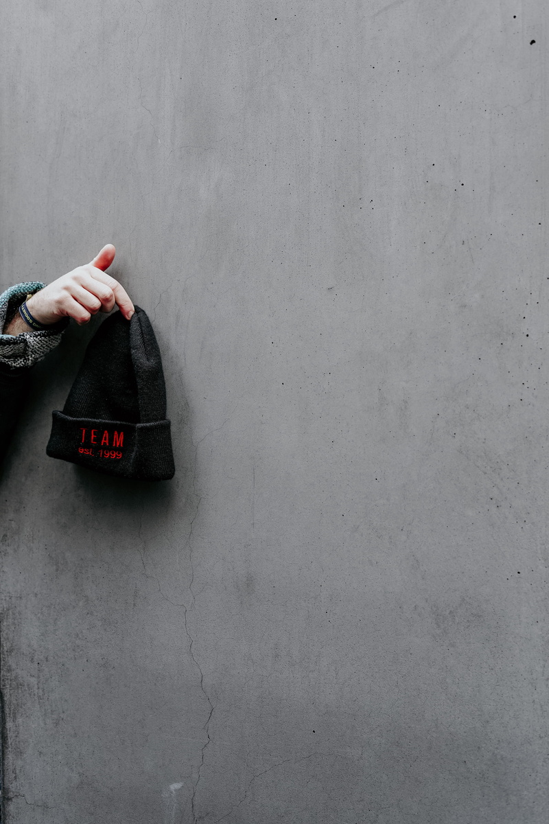 holding, body part, gemstone, pants, black, apparel, wall - building feature, clothing, robe, one person, copy space, overcoat, tool, suit, concrete, jewelry
