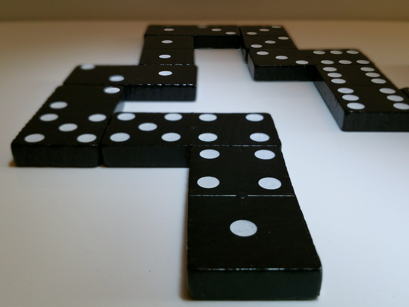 dice, arts culture and entertainment, opportunity, still life, black color, dominoes, gesellschaftsspiel, high angle view, white color, indoors, technology