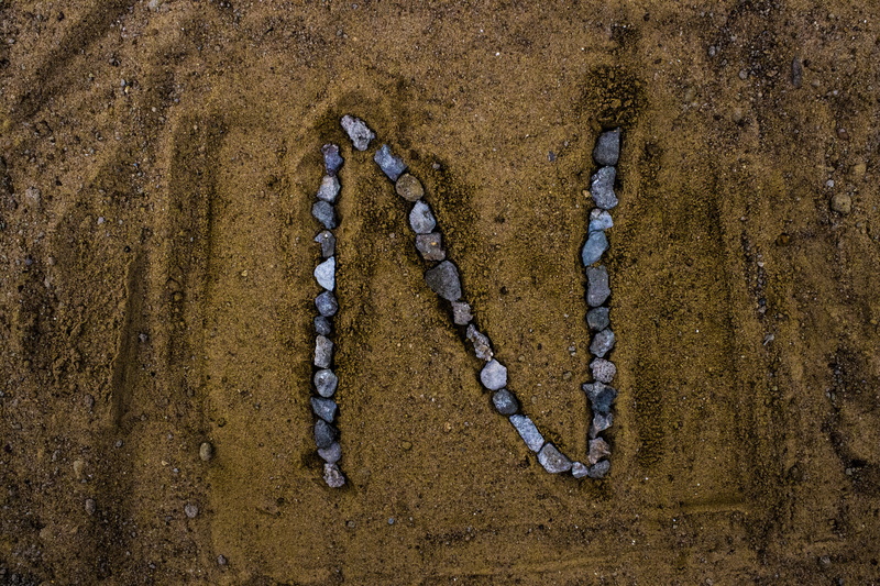 english alphabet, land, sunlight, metal, alphabet n, no people, n, 5K, jewelry, textured, beach, alphabet, high angle view, alphabetical, nature, chain