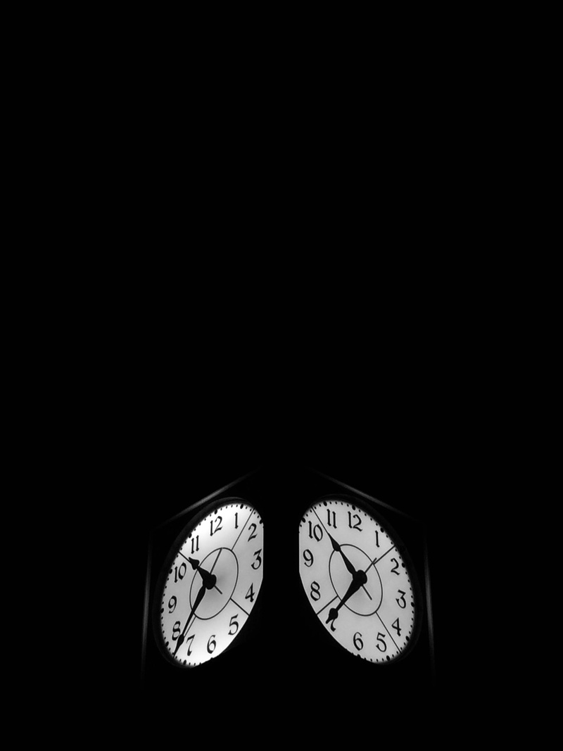 indoors, illuminated, time, copy space, dark, night, two, wall clock, instrument of time, analog, number, accuracy, black background, no people, personal accessory
