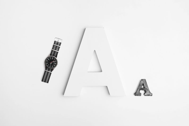 watch, design, colors, capital letter, high angle view, indoors, cutout, a, white background, western script, shape, technology, sign, no people, communication