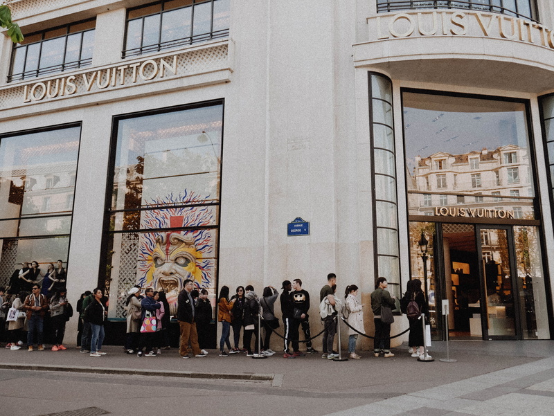 building, street, people, text, vuitton, city life, real people, women, architecture, store, outdoors, lifestyles, crowd, office building exterior, queuing