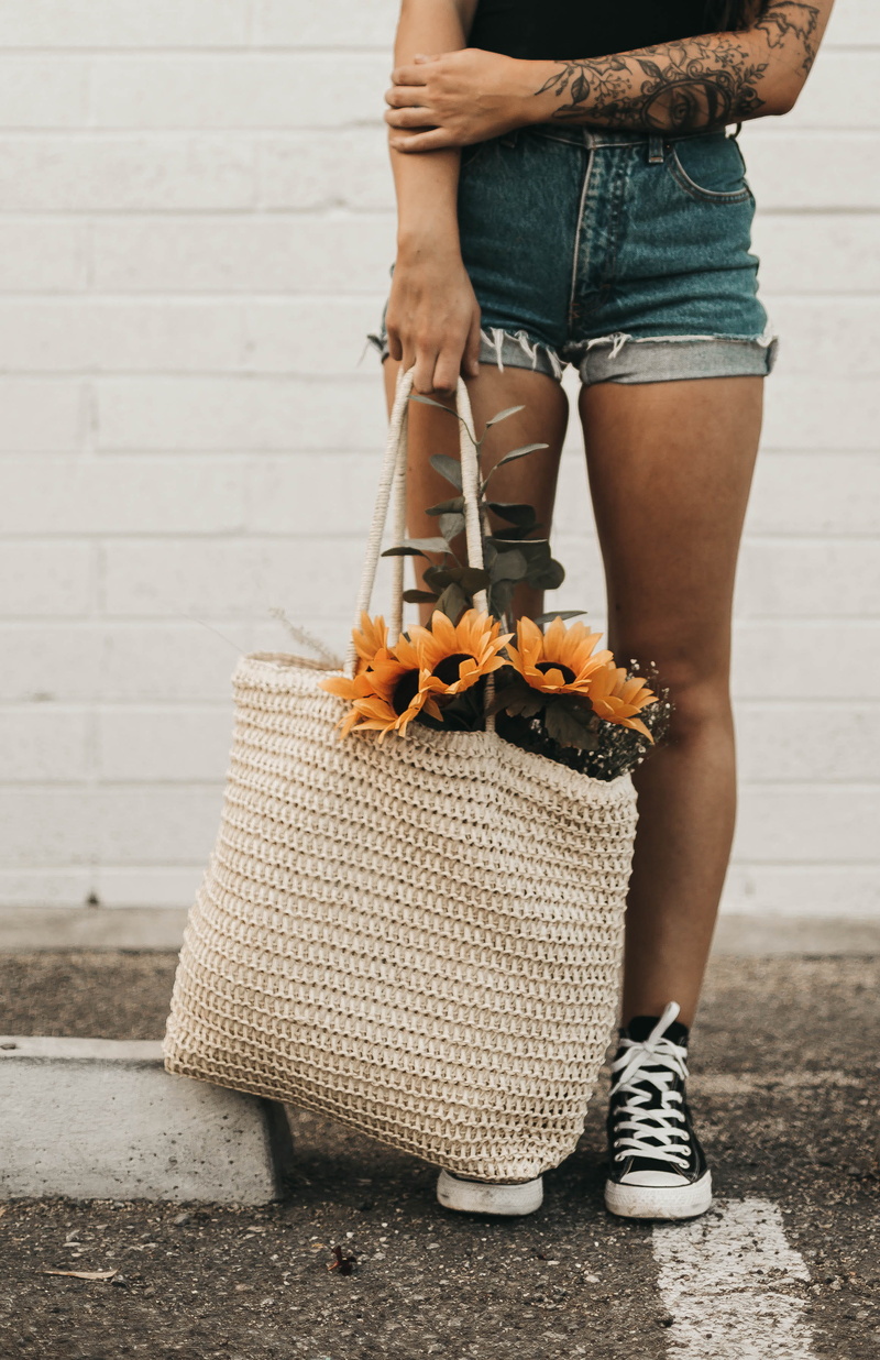 blossom, jeans, footpath, bag, shoe, focus on foreground, food, handbag, apparel, human leg, footwear, one person, 2K, accessory, shorts, low section