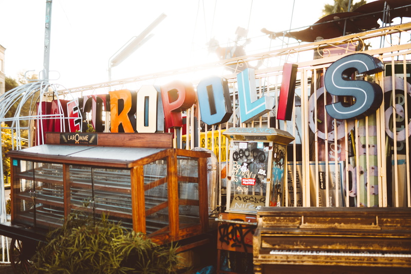 plywood, text, wood, dining room, playground, building exterior, leisure activities, metropolis, restaurant, city, bench, outdoors, large group of objects