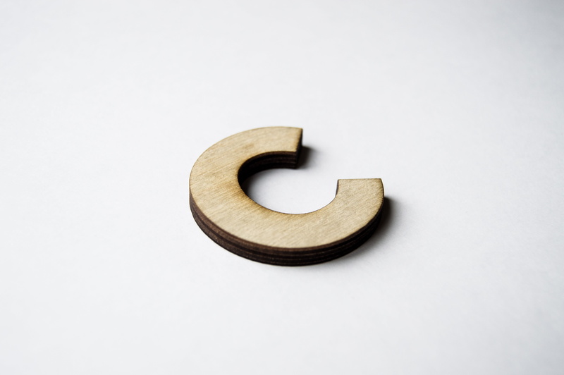 brown, metal, accuracy, art and craft, lasercut, wood - material, simplicity, wood, creativity, single object, letter, high angle view, shadow, alphabet
