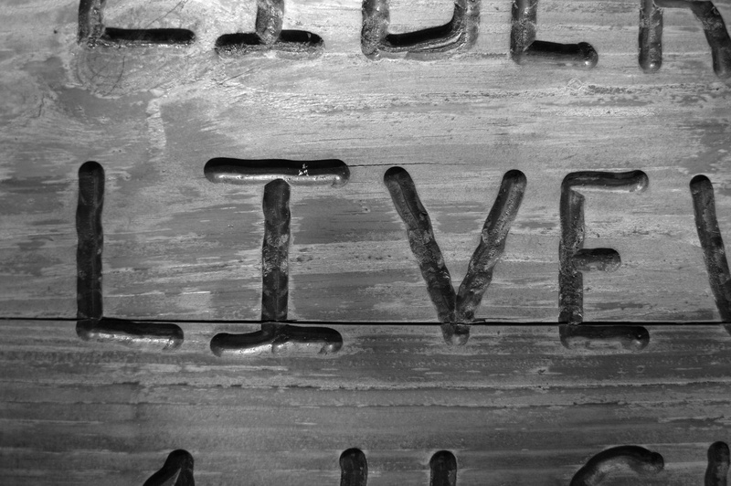 black and white, metal, wall - building feature, word, no people, textured, full frame, decorative, communication, dark, western script, indoors, live