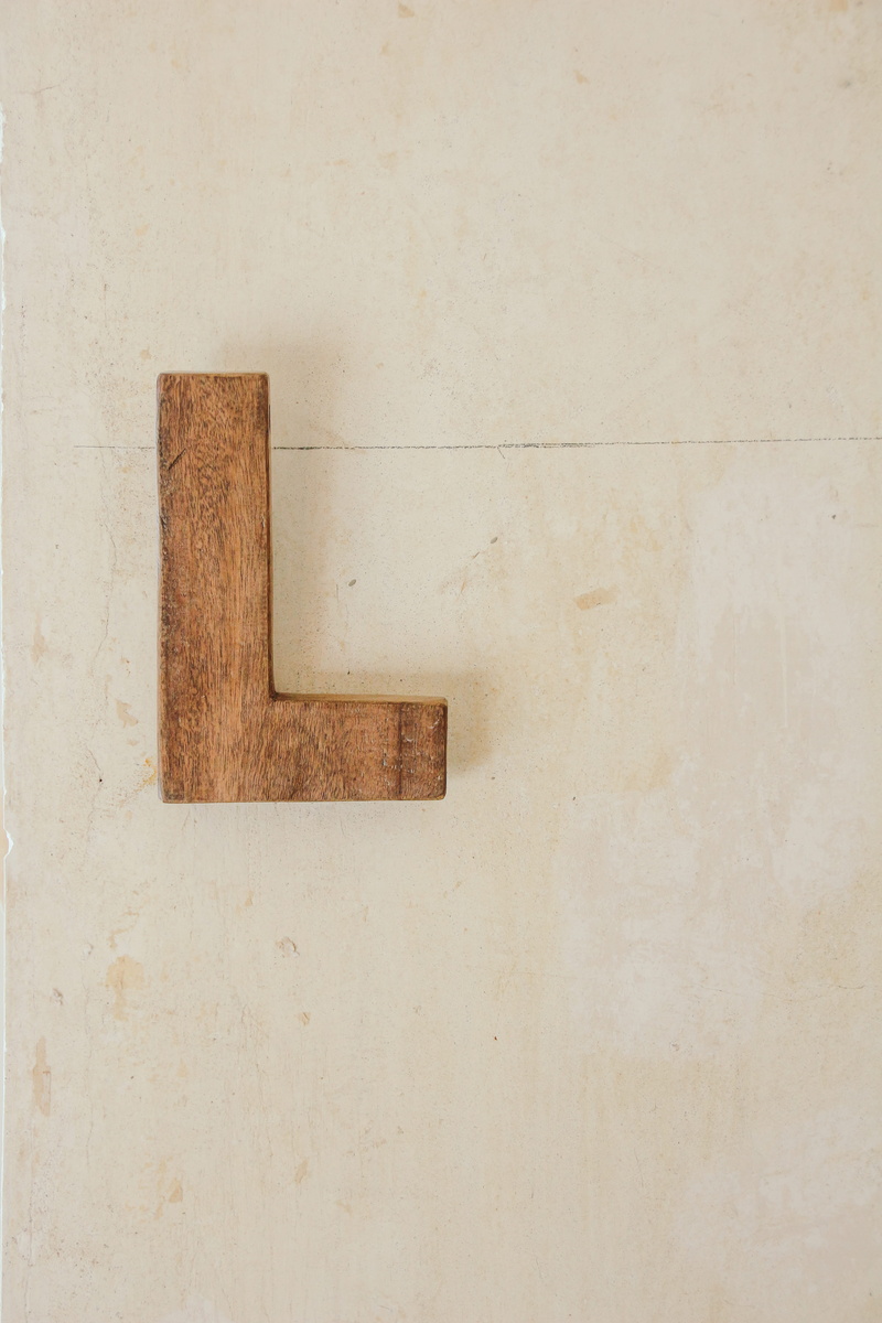 brown, freestanding, textured, wooden, indoors, day, geometric shape, architecture, close-up, copy space, 5K, wall, entrance, pattern, no people, letter