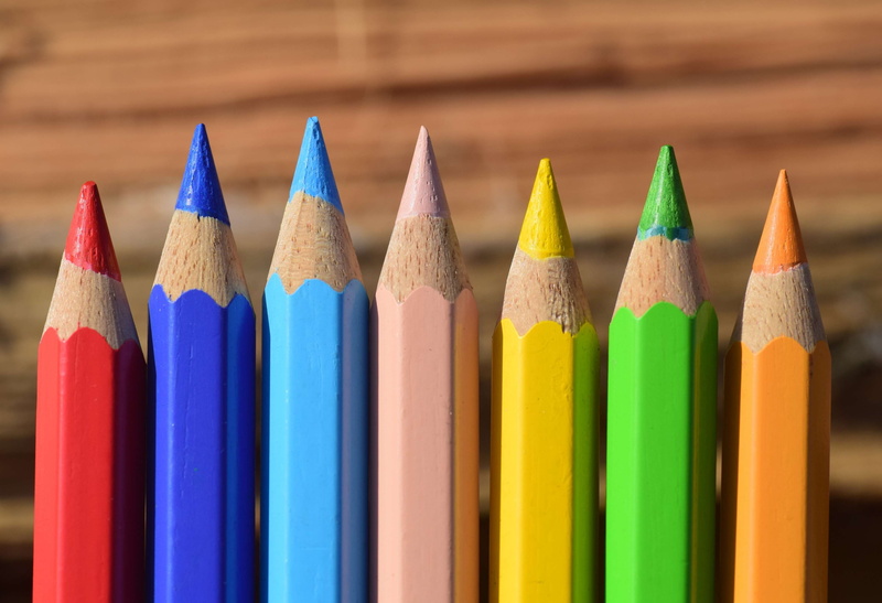 colorful wooden pegs, art, no people, different colored crayons, pointed, writing instrument, indoors, school, wooden pegs, in a row, art and craft equipment