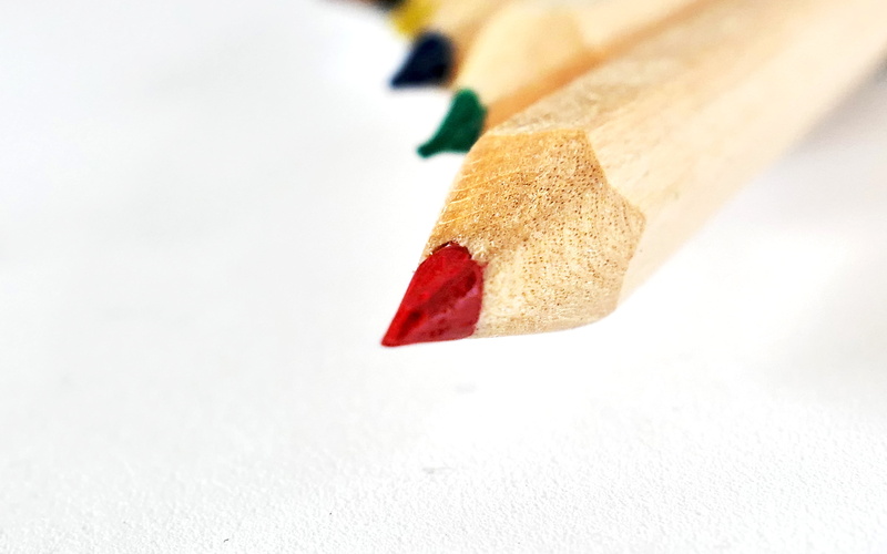 wooden pegs, white background, selective focus, cut out, paint, colorful, studio shot, no people, focus on foreground, pencil, crayons, pens, creativity