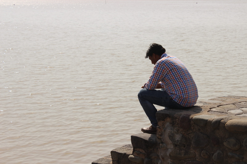 leisure activity, Man, real people, day, shore, male, young men, rock - object, young adult, lifestyles, outdoors, rear view, Water, Chandigarh, men, solid