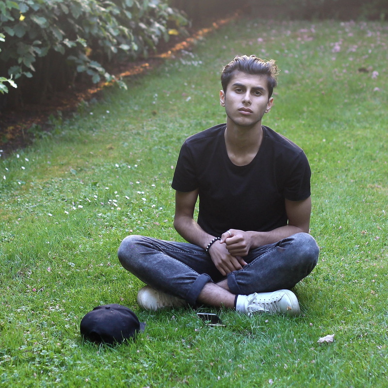 looking at camera, teenage boys, grass, 1080P, contemplation, field, portrait, nature, one person, green color, front view, casual clothing, lifestyles