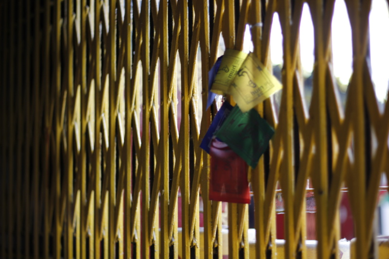 symbol, spirituality, clothing, yellow, hanging, modern art, triangle, metal, arrow, wood - material, shades, incense, wall - building feature, motion