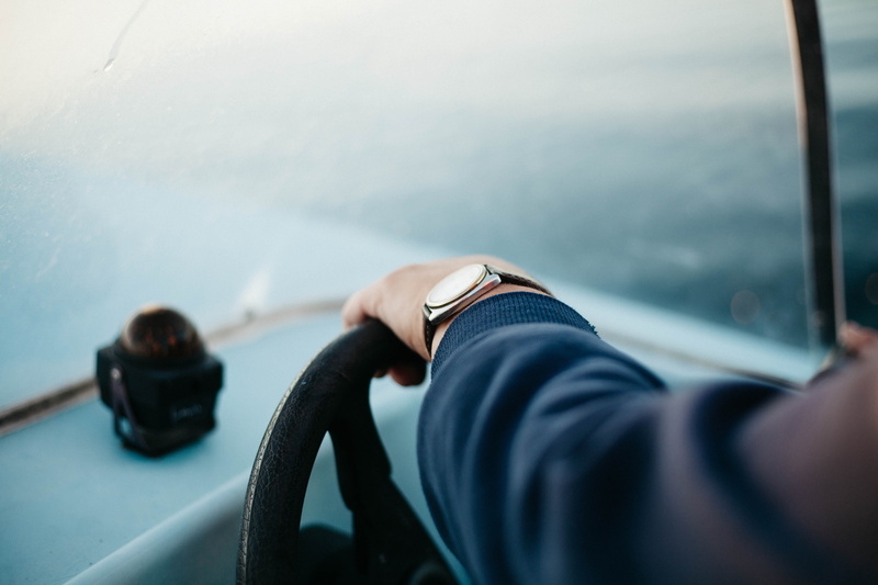 mode of transportation, ship, day, men, selective focus, steering wheel, nature, selective, real people, human body part, leisure activity, focus, sea