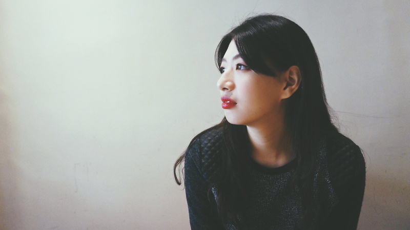 women, headshot, beautiful woman, black hair, portuguese, casual clothing, wall, contemplation, lateral face, one person, indoors, wall - building feature