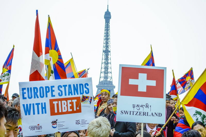 apparel, protestor, crowd, trademark, brochure, day, flyer, human, government, city, rally, togetherness, flag, switzerland, vacation, daytime, protest