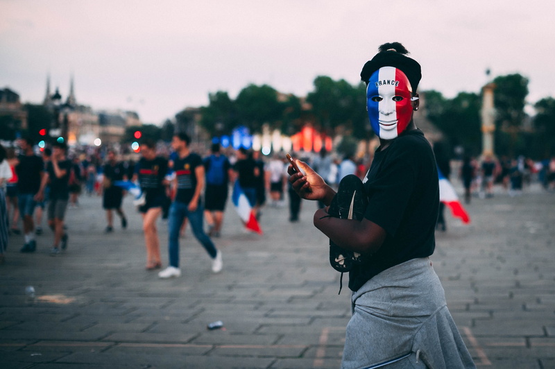 side view, street, crowd, men, selective, incidental people, adult, clown, festival, finger, human, focus on foreground, one person, focus, shorts, leisure activity