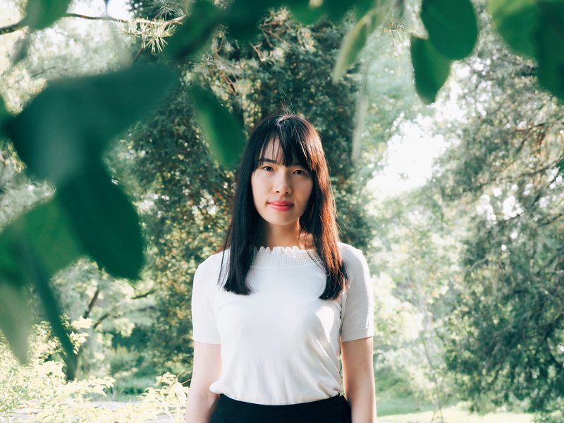 young Adult, asian, leisure activity, casual clothing, haired, contemplation, standing, showing, looking at camera, front view, brown Hair, trees, daytime