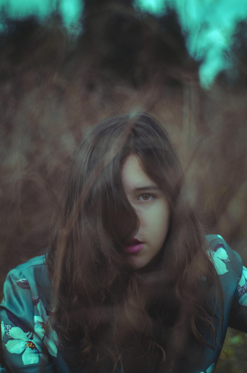 one Person, low, leisure activity, light, teenager, one woman only, nature, beauty, blue, beautiful, headshot, focus on foreground, tree, eyes, human Face