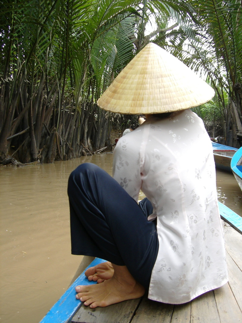 sitting, asian style conical hat, boat, clothing, leisure activity, real people, water, women, relaxation, adult, hat, balance, day, boating, lifestyles