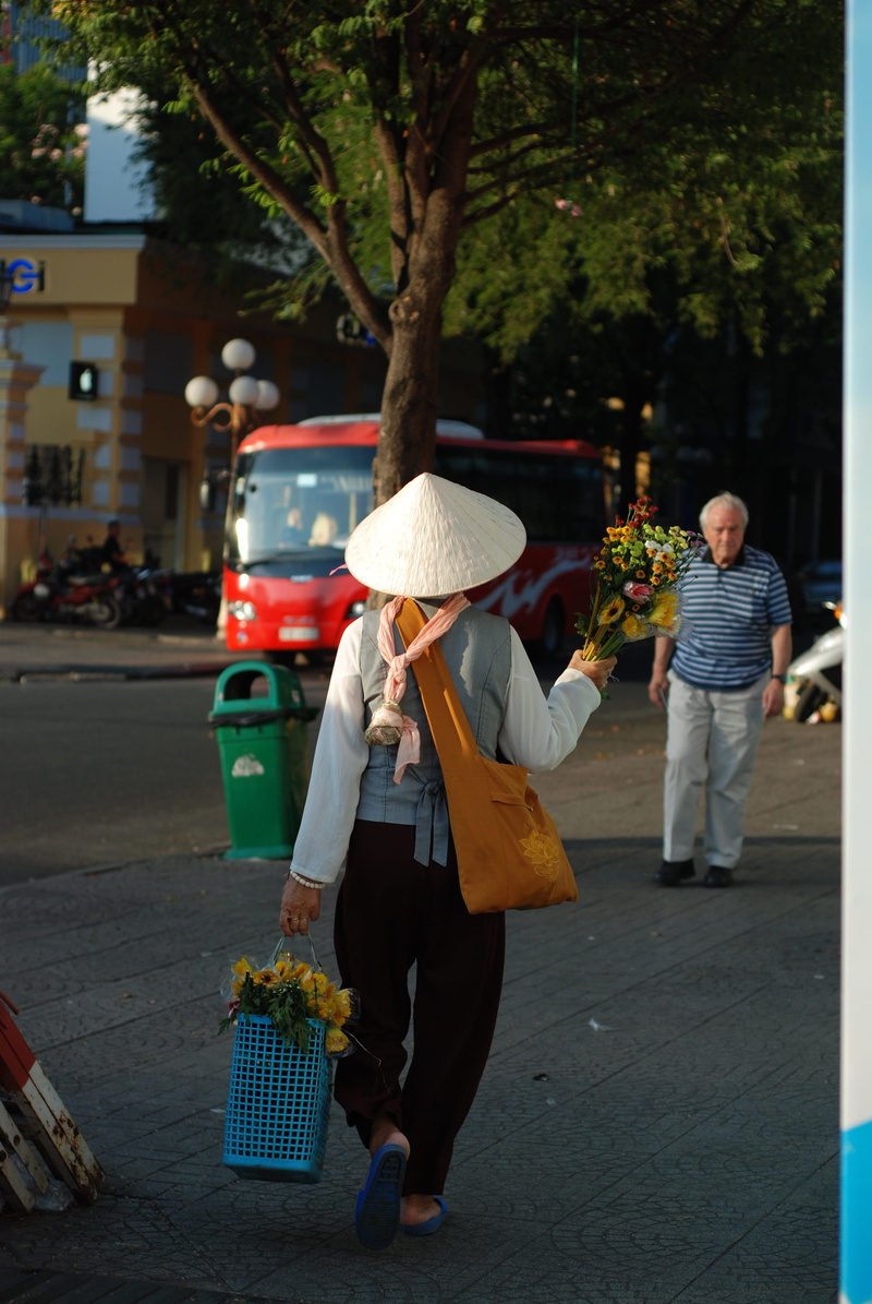 street, city, basket, rear view, hat, road, clothing, incidental people, food, land vehicle, sunny, container, asian style conical hat, carrying, retail