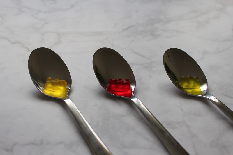medium group of objects, kitchen utensil, red, 5K, still life, indoors, haribo, food, gummibärchen, color, table, reflection, colorful, group of objects