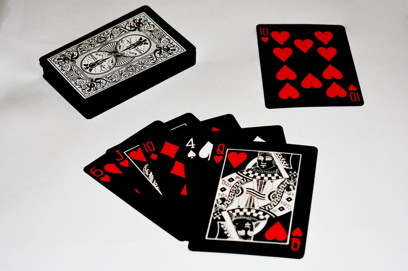 heart, gambling, indoors, casino, studio shot, white, male likeness, wireless technology, a deck of cards, card game, money, smart phone, luck, no people